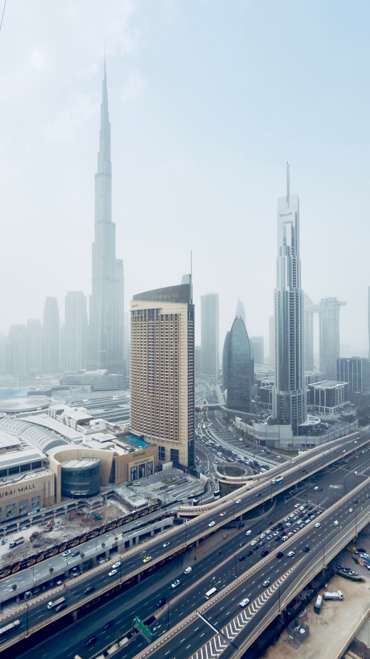 Downtown Dubai towers standing in morning fog